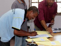 A man signs a form.