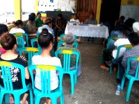 Community members watching a presentation.