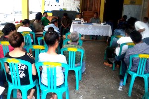 Community members watching a presentation.