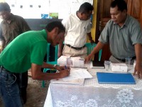 A man signs a form.