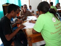 People gathered around a table draw a map.