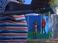 A man turns on a tap