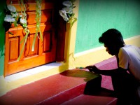 A man paints a doorframe.