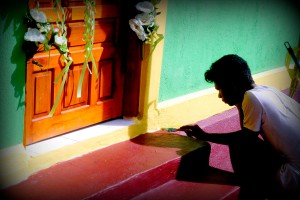 A man paints a doorframe.