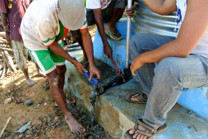Men working on a water pipe.