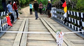 A wooden bridge, decorated with ribbons and flags