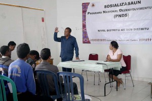 A man explains PNDS to a room of people.