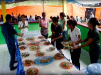 Women from the community in Sabuli serve lunch in the new community centre as part of the inauguration ceremony.