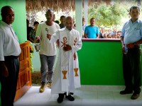 Father Deonizio Bere blesses the new community centre in the presence of Secretary of State Mendonca, Metinaro sub-district administrator Fausto Soares Dias, and members of the community.