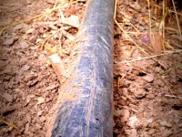 Black PVC piping in the dust.