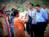 A community member welcomes Minister for State Administration, Jorge Teme.