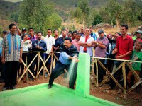Minister for State Administration Jorge Teme opens a new water tap.