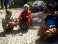 Women from suku Abo prepare wire ties to be used in the frame work of their new health clinic