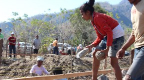 Women help with the construction of a community center in Oecusse