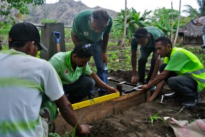 A CNEFP trainer works with a PNDS technical facilitator to check a water tap.