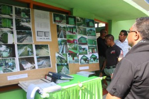 The Prime Minister, Rui Maria de Araujo looks at the pictures of PNDS projects that the community has already finalized