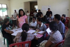 The Village Management Team participating in a discussion on the materials presented by the Administrative Post Social Facilitators